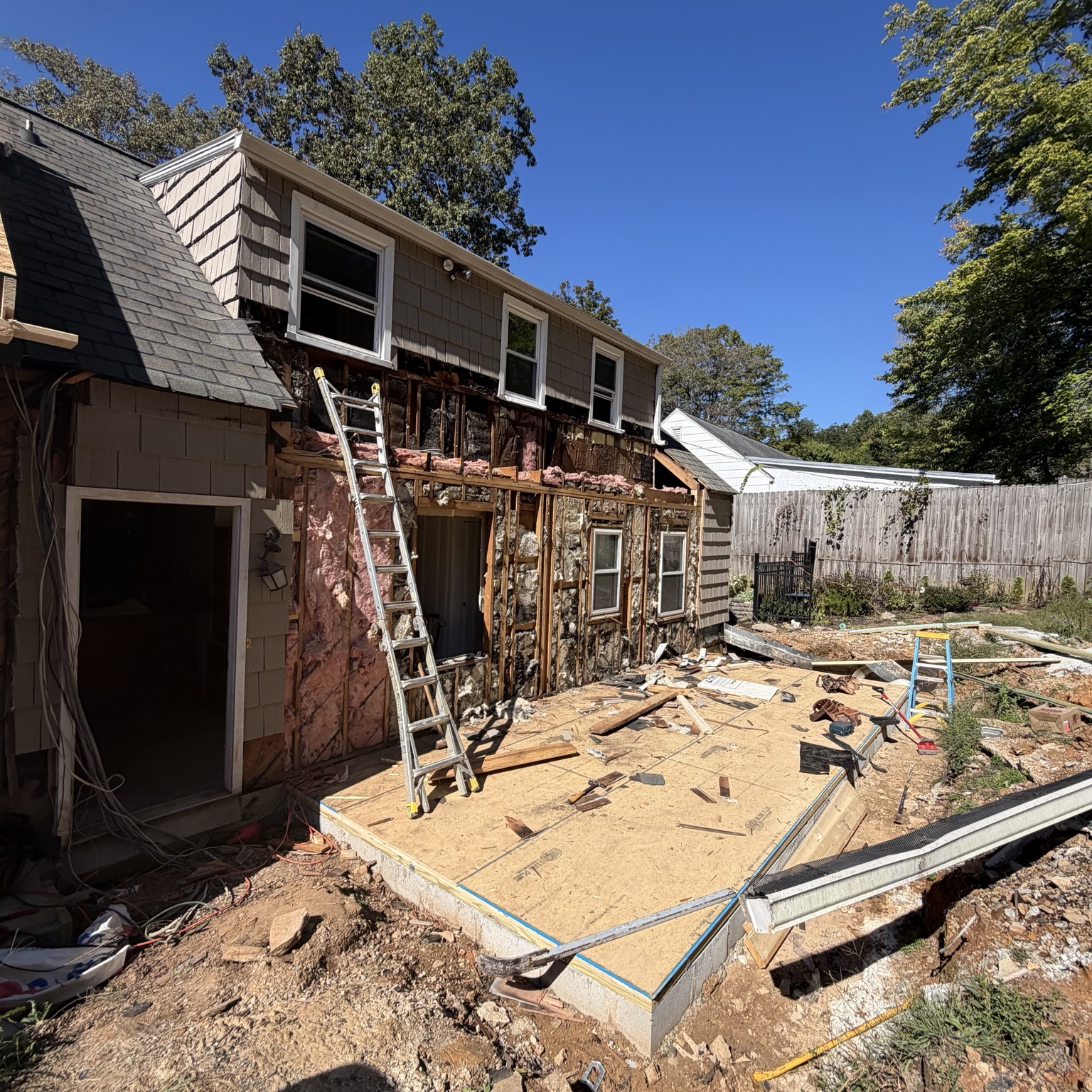 Exterior remodeling with exposed framing and scaffolding
