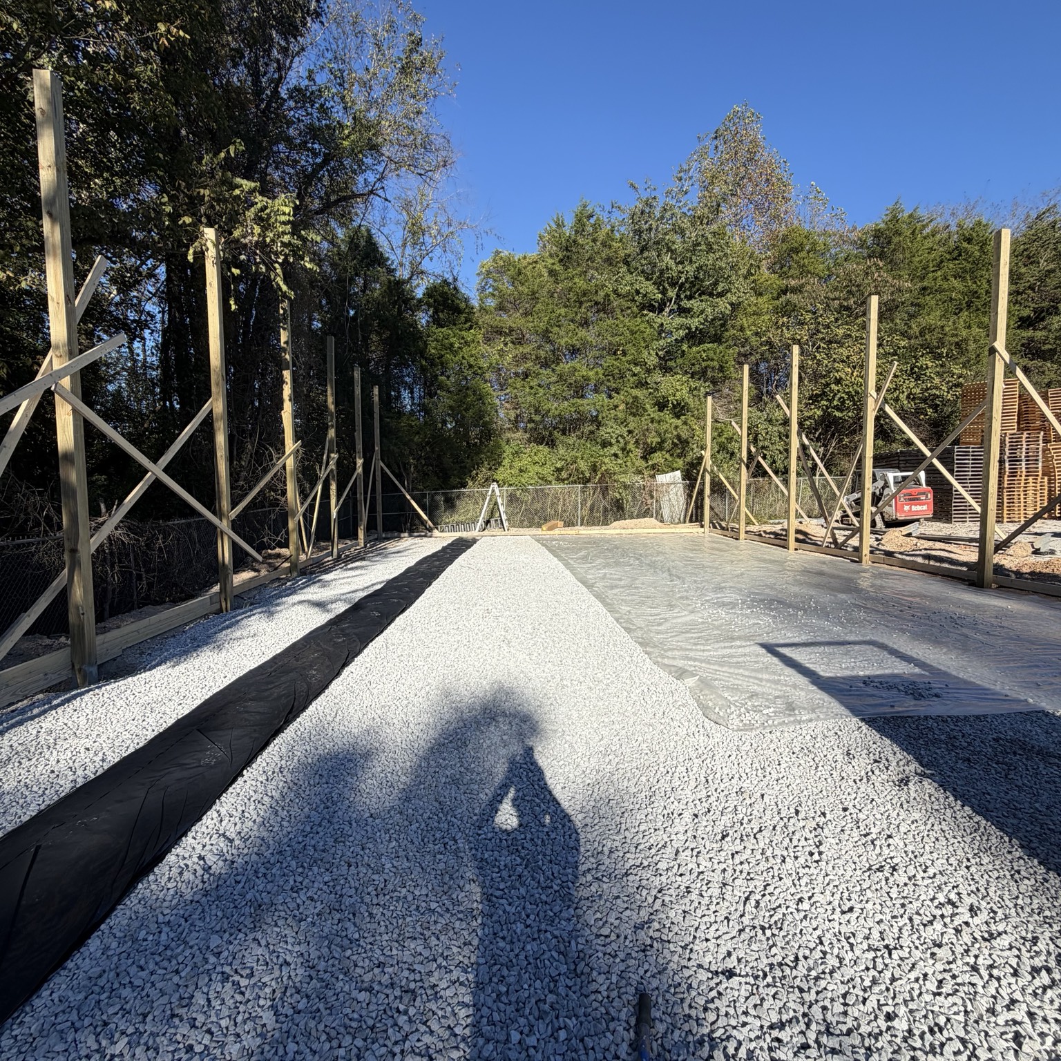 Prepared gravel base with posts along the slab perimeter