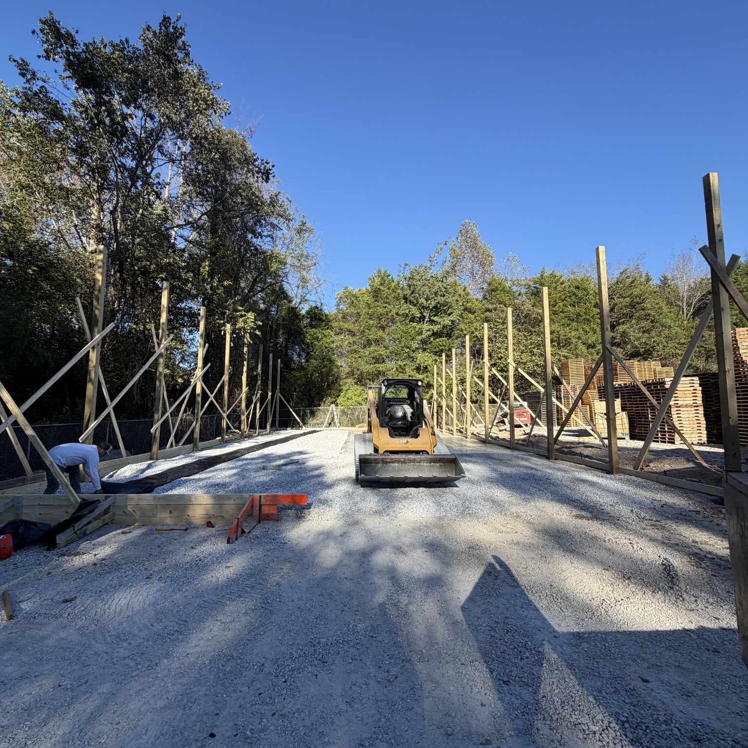 Concrete slab preparation with a compactor and braced posts