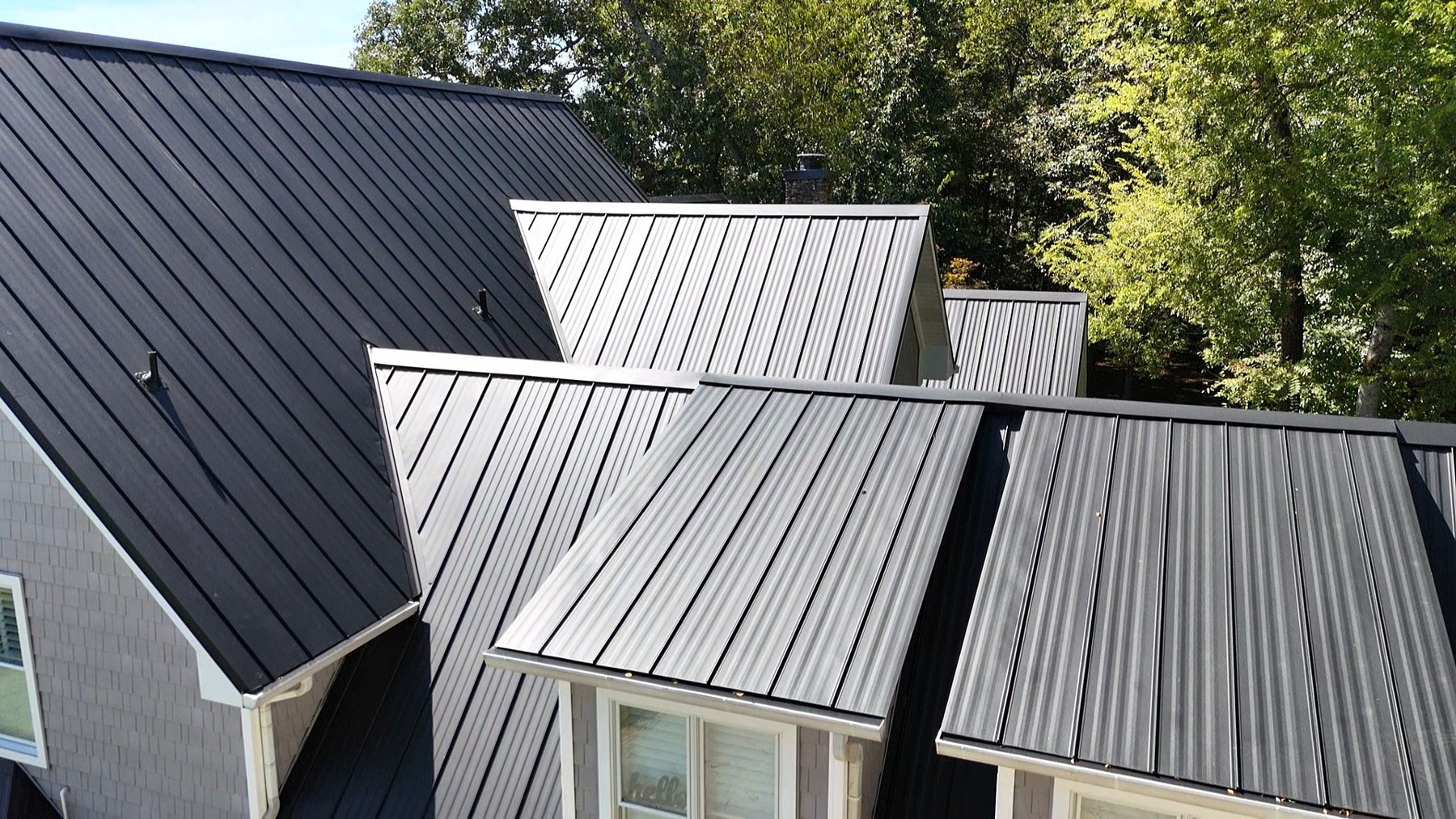 Detail of standing seam metal roofing installed by AA Compass Construction