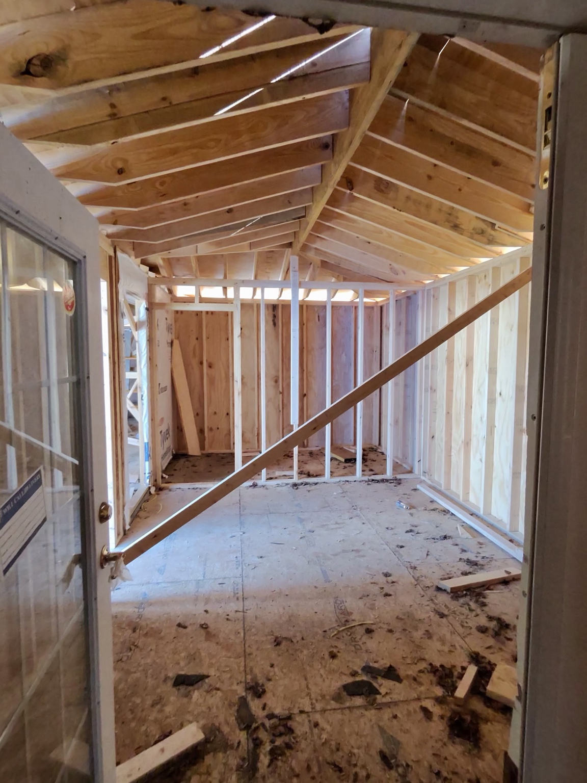 Wood wall studs and roof framing in progress
